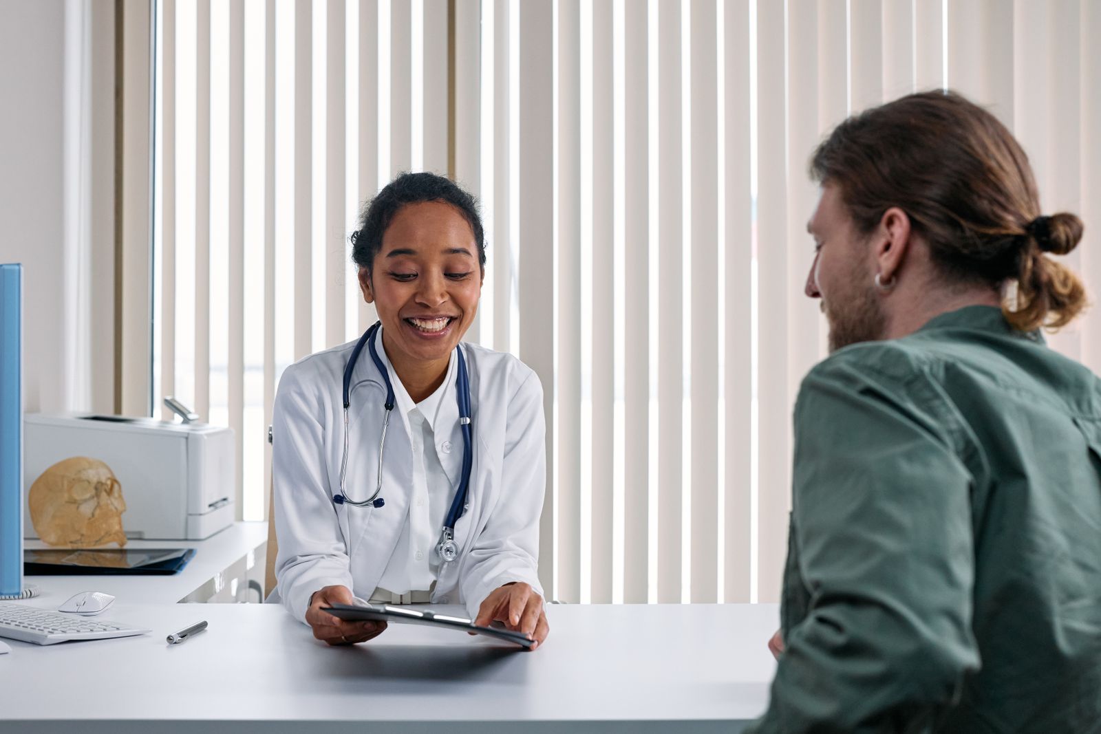 Friendly doctor consulting with a patient during a primary care visit